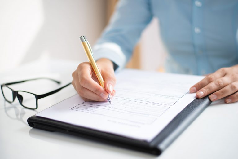 closeup of business woman making notes in document 1